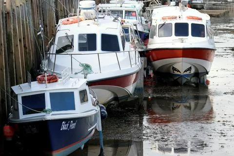 Three Boats in Looe Harbor Stock Photos