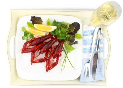 Three boiled crayfish with lemon, lettuce and champagne Stock Photos
