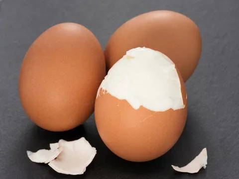 Three boiled eggs on slate background Фото