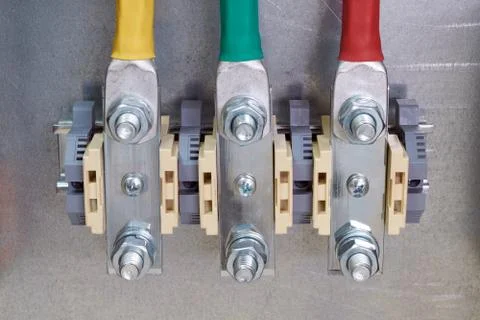 Three bolt-through terminals in the electrical Cabinet. Stock Photos