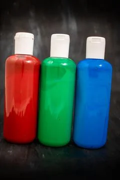 Three bottles of acrylic paint Stock Photos