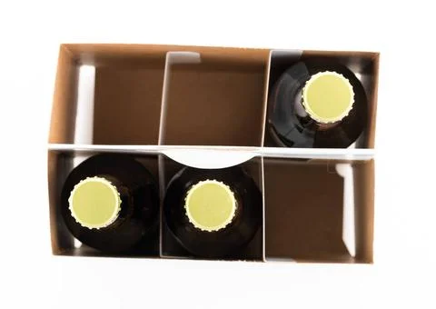 Three bottles of beer with caps facing camera Pattern of three beer bottle... Stock Photos