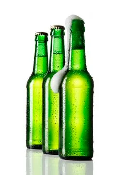 Three bottles of beer, one opened Stock Photos