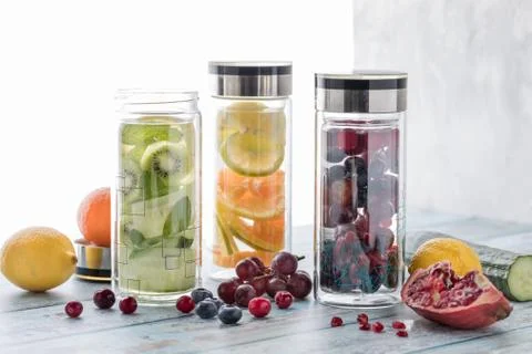Three bottles of different fruit and vegetable infused flavoured water. Stock Photos
