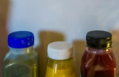 Three bottles of fruit and vegetable smoothies in a refrigerator, popular and Stock Photos