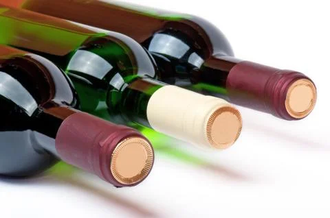 Three bottles with red and white wine Stock Photos
