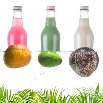Three bottles with various fruit drinks and tropical fruits on the surface of Stock-Fotos