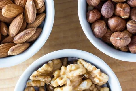 Three bowls of assorted nuts Stock Photos