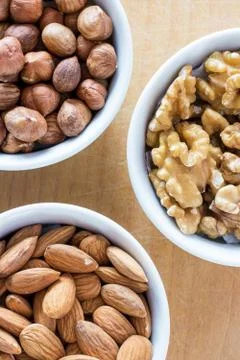 Three bowls of assorted nuts Stock Photos