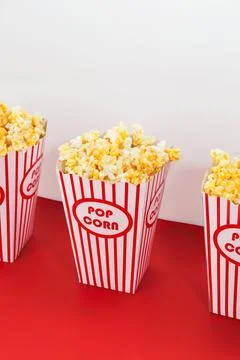 Three boxes of crisp popcorn in candy striped packaging Stock Photos