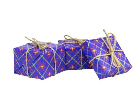 Three boxes of gifts packed in festive blue packaging, white background. Stock Photos