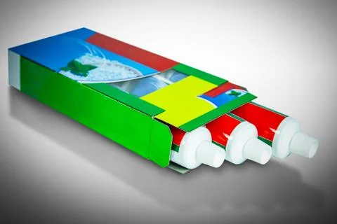 Three boxes of toothpaste pack size isolated on white background Fotos de archivo