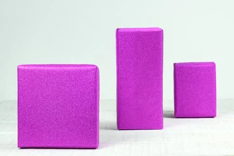 Three boxes wrapped in a gift paper on white background Velvet violet Foto stock
