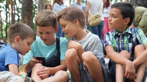 Three boys playing video game. Three brothers with gadget. Faces of three boys Stock-Footage 137575455