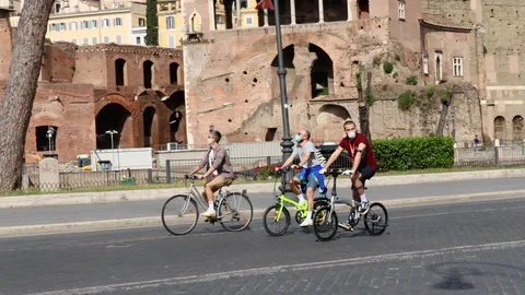 Three boys ride a bicycle on the streets of the city. Stock Footage 130142712