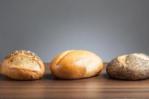 Three bread rolls on table Stock Photos