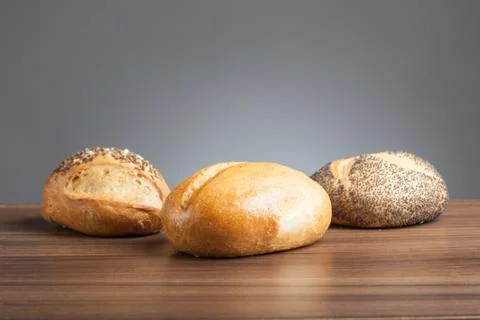 Three bread rolls on table Stock Photos