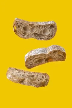 Three bread slices levitation on yellow background Stock Photos