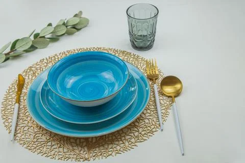 Three bright blue serving plates with a spiral pattern of different sizes stand Stock Photos