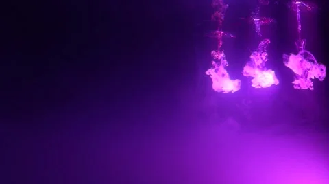 Three Bright Bursts of Smoke Highlighted in a Purple Cloud Tank Stock Footage 62578876
