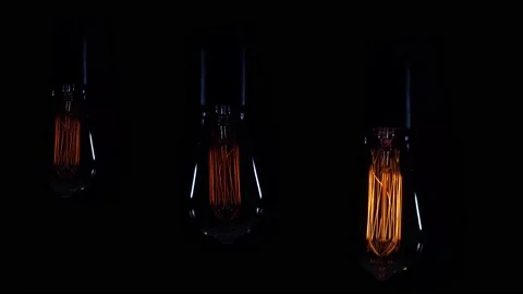 Three bright orange spiral retro style incandescent bulbs. Nostalgia lamp on  Video stock 170744899