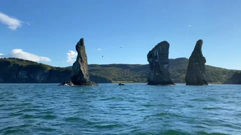 Three Brothers is a group of three pillar-like rocks protruding from the water Video stock 141455862