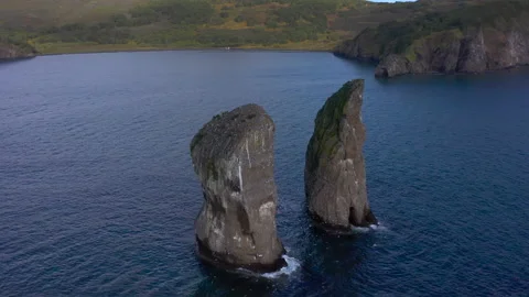 Three Brothers is a group of three pillar-like rocks protruding from the water Video stock 142917569