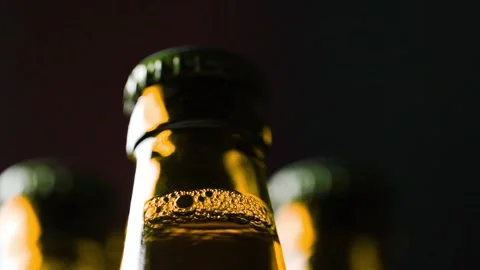 Three brown bottles turning in the dark Stock Footage 150931361