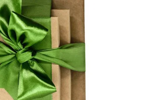 Three brown carton gift boxes bundled with green ribbon Stock Photos