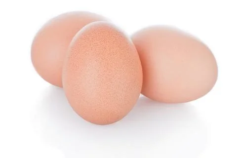 Three brown chicken eggs isolated on white background. Stock Photos