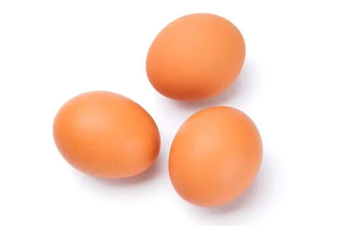 Three brown eggs isolated on white Stock Photos