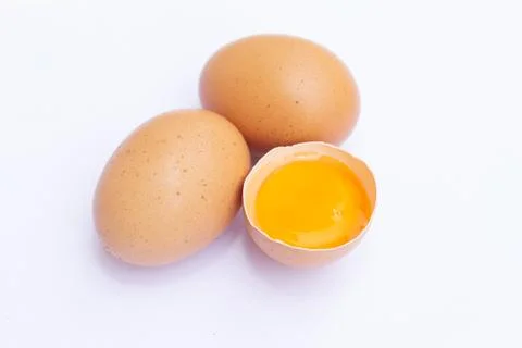 Three brown Eggs with one has broken isolated on white background Foto stock