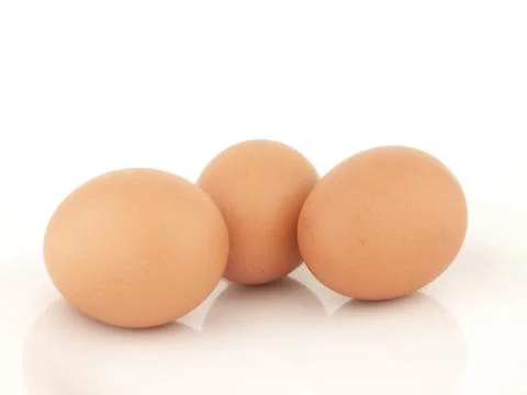 Three brown eggs Stock Photos