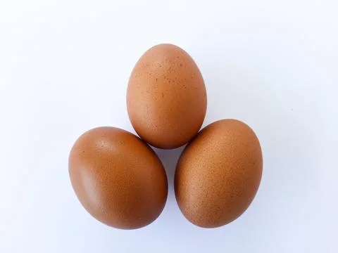Three Brown Eggs on White Background Fotos de archivo