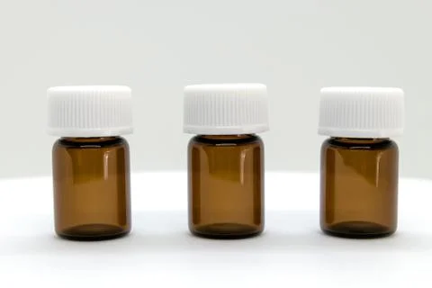 Three Brown Sample Bottles with White Caps Stock Photos