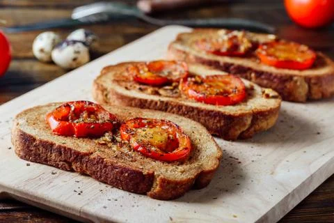 Three Bruschettas on Cutting Board Stock Photos