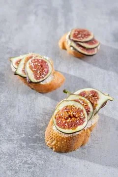 Three bruschettas with fresh slice figs Stock Photos