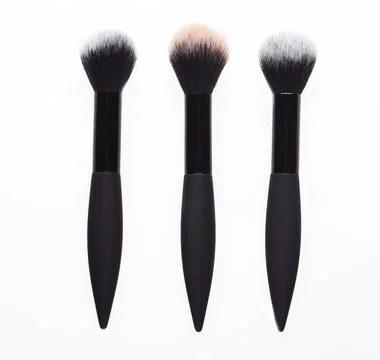 Three brushes for powder on white background Stock Photos