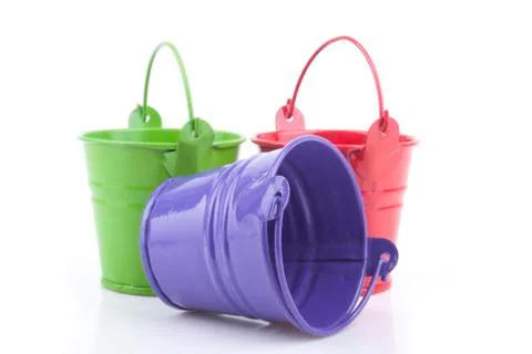 Three buckets of different colors, isolated on white background. Stock Photos