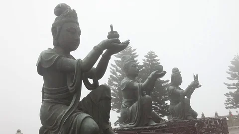 Three Buddhist Offering Statues in exteme Fog Stock Footage 104418441