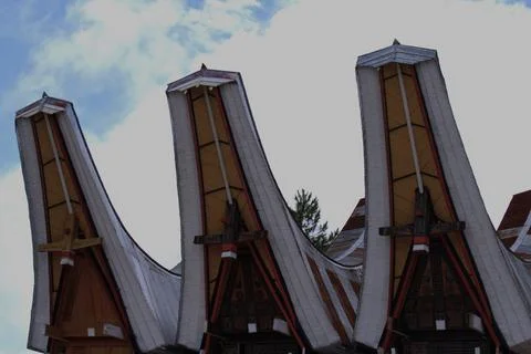 Three buildings with triangular roofs Stock Photos