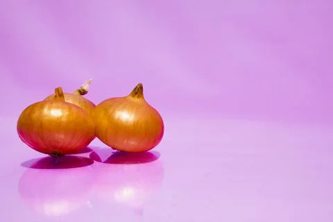 Three bulbs lie in the left corner on a pink background. Vitamins, space for Stock Photos