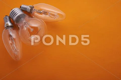 Three bulbs on an orange background Stock Photos