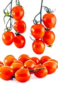 Three bunches of small tomatoes: two bunches hanging down from above, one is  Stock Photos