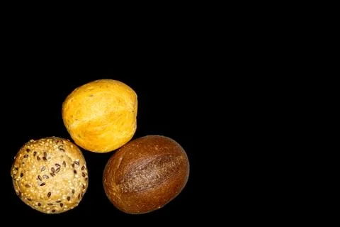 Three buns isolated on a black background. Selective focus. Stock Photos