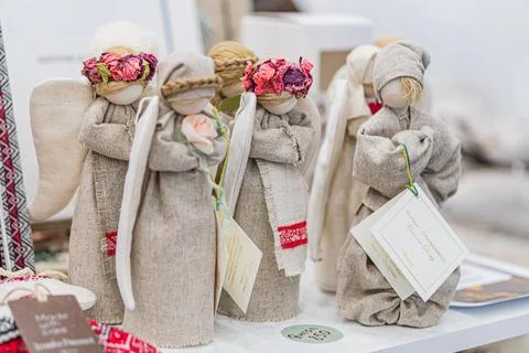 Three burlap angels on a white table at the Ukrainian fair, distinctly deco.. 写真素材
