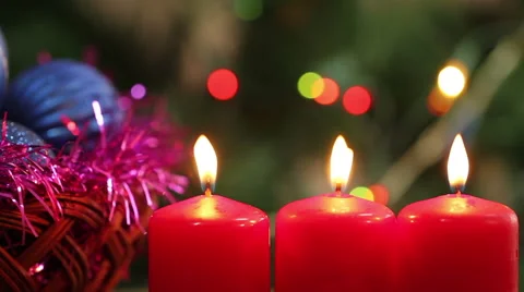 Three burning candles on a background garlands blinking Stock Footage 66356015