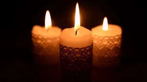 Three burning candles in the dark Stock Footage 71811832