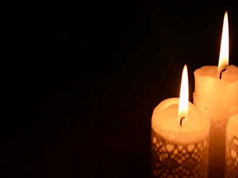 Three burning candles in the dark Stock Footage 71812337