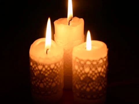 Three burning candles in the dark Stock Footage 71812765